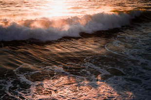 ocean waves at sunset with reflections and foam serene beach landscape