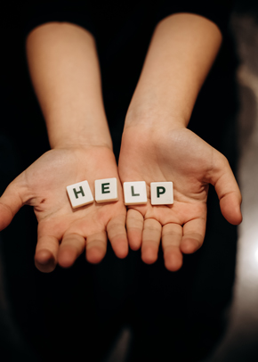 hands holding letter tiles spelling help providing support and assistance 4 ways to reach out