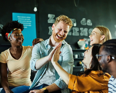 group of friends enjoying laughter and high-fives in a casual setting happiness and connection with positive energy