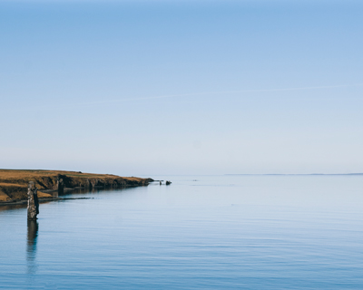 calm ocean view with clear blue sky and distant horizon peaceful landscape 1 shore tranquility